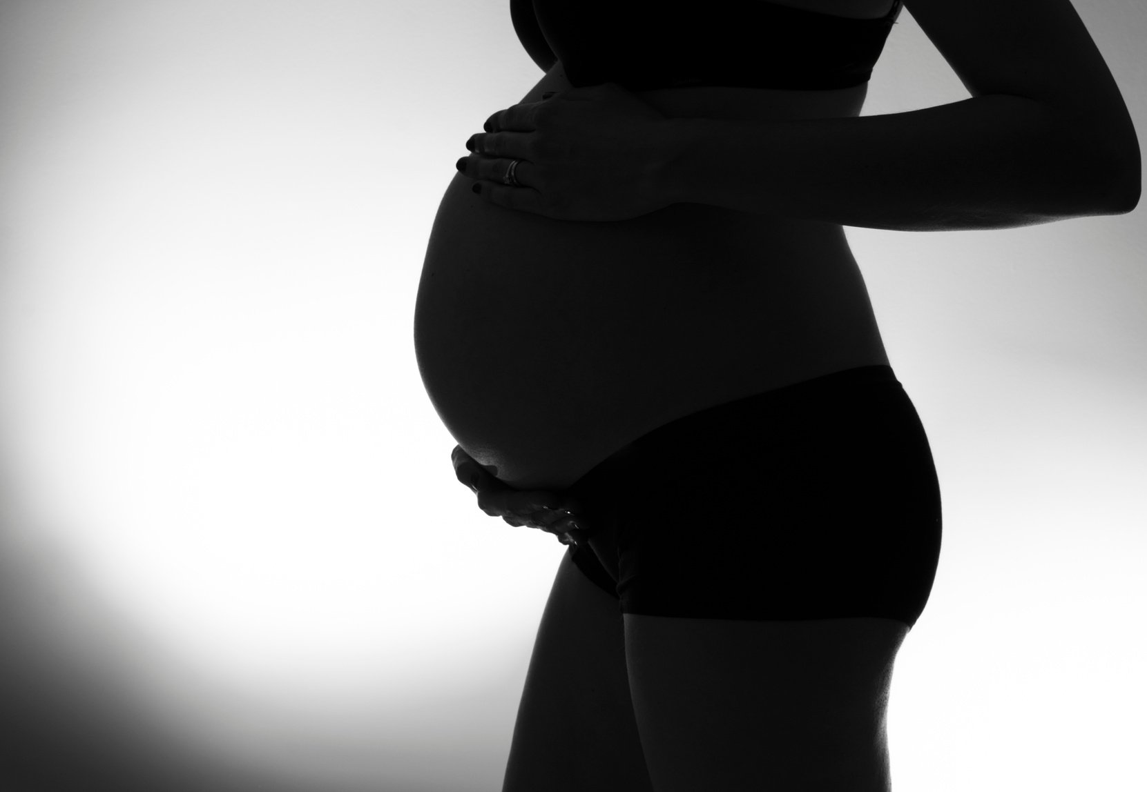 Black and White Silhouette of a Woman's Pregnant Belly